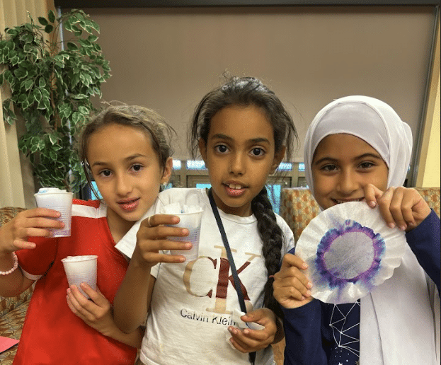 Three people reviewing a document together in a modern office setting